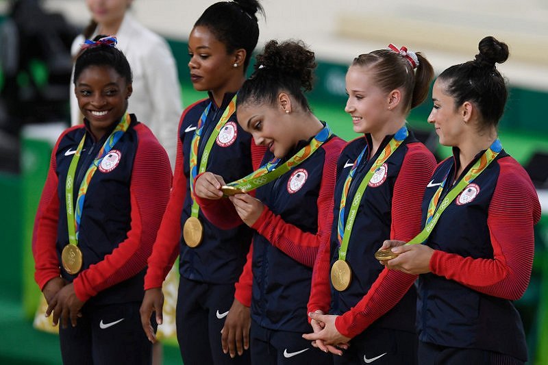 From_left__Simone_Biles__Gabrielle_Douglas__Lauren_Hernandez__Madison_Kocian_and_Alexandra_Raisman_celebrate_their_gold_after_the_women_s_team_gymnastics_final.jpg