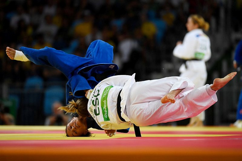 Laura_Gomez_of_Spain__right__and_Gulbadam_Babamuratova_of_Turkmenistan_go_airborne_during_judo_action.jpg